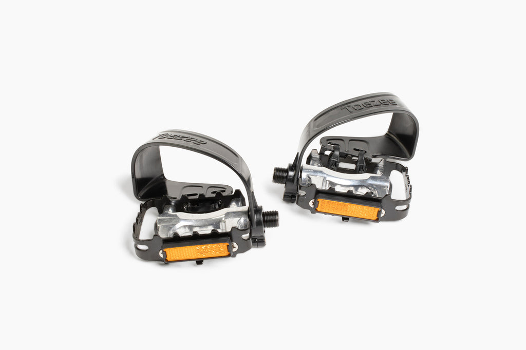 Toezee™ pedal clip installed on standard bike pedal, showing easy attachment and secure fit.