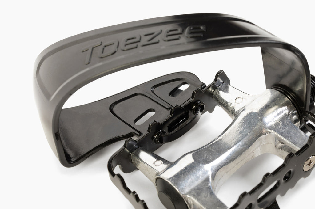 Toezee™ pedal clip installed on standard bike pedal, showing easy attachment and secure fit.